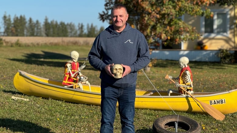 Man holding fake skull.