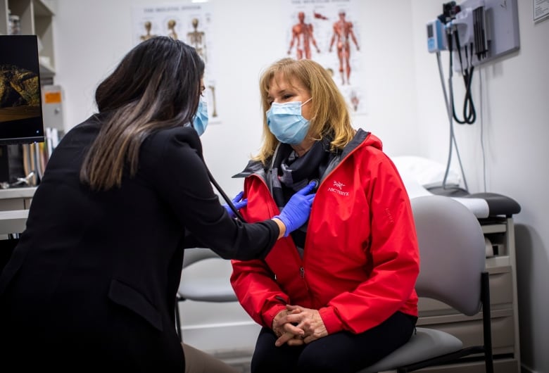 A nurse practitioner with a patient at a clinic.