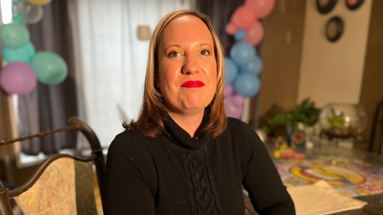 Meghan Smart sitting at her dining room table.