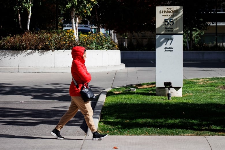 A person walks past an apartment building.