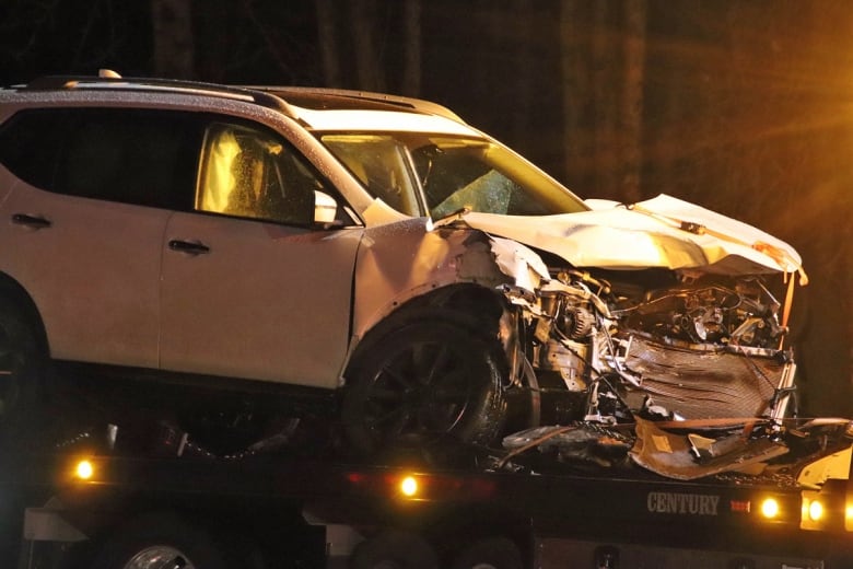 An SUV with its hood and bonnet smashed and bent after an a collision.