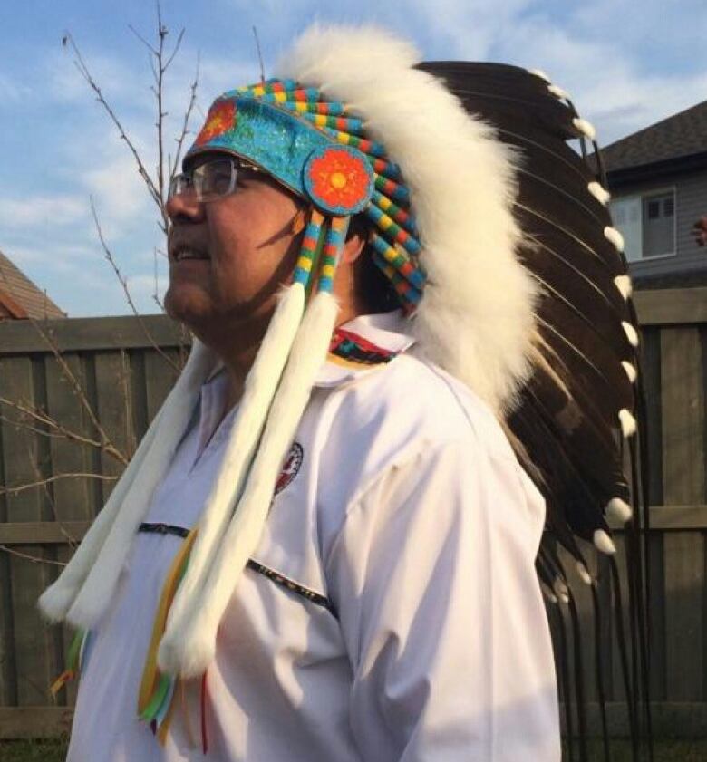 A headshot of a man in a headdress.