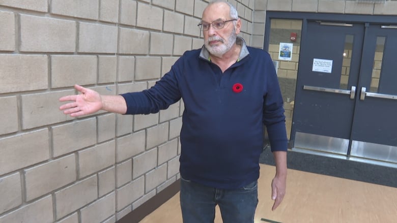 Windsor Pickleball Club president Patrick Brown points to the wall where a man hit his head in June and where they would like padding installed.