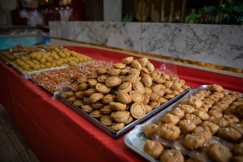 A series of fried sweets lie on a table.