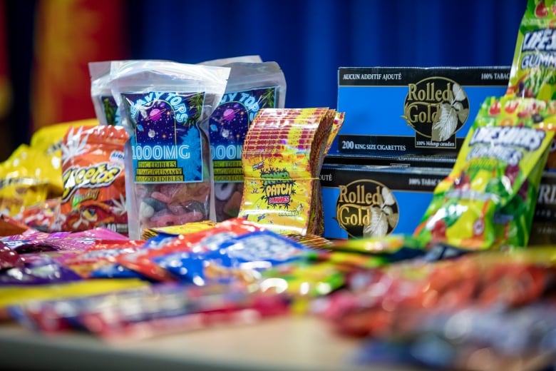 A series of candy packets sit on a table.