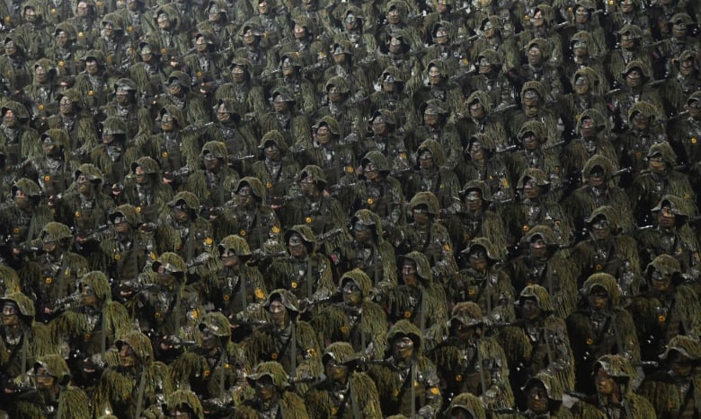 Uniformed North Korean soldiers march in a military parade. 