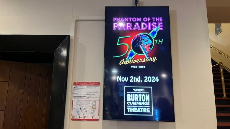 A film poster on a wall that says 'Phantom of the Paradise 50th anniversary Nov. 2nd 2024.'