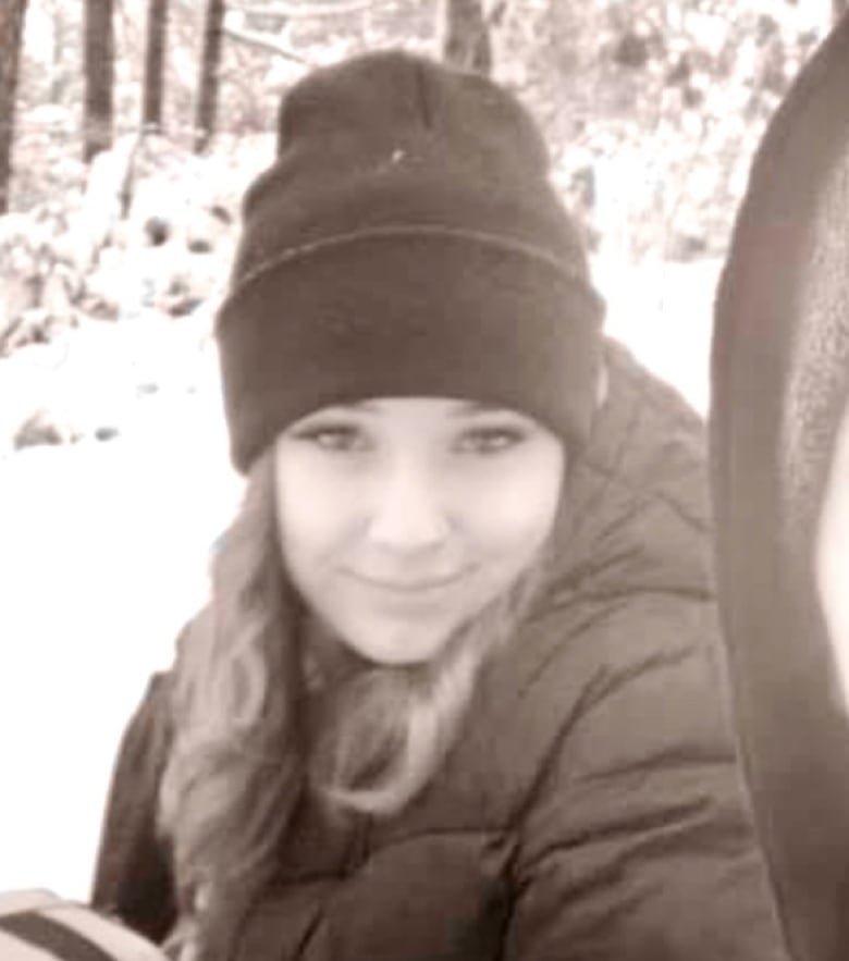 A filtered photo of a teen outdoors wearing winter clothing.