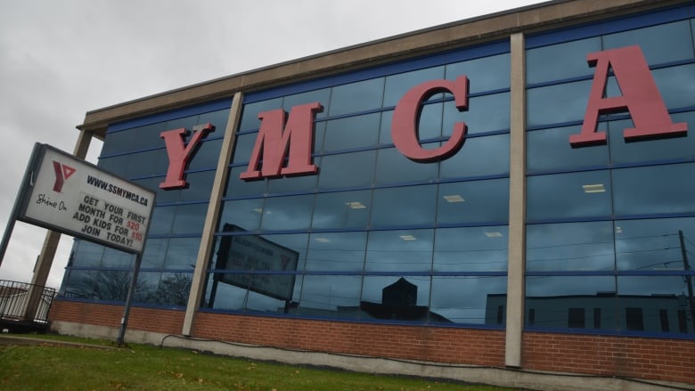 A glass building with the letters Y-M-C-A on the outside 