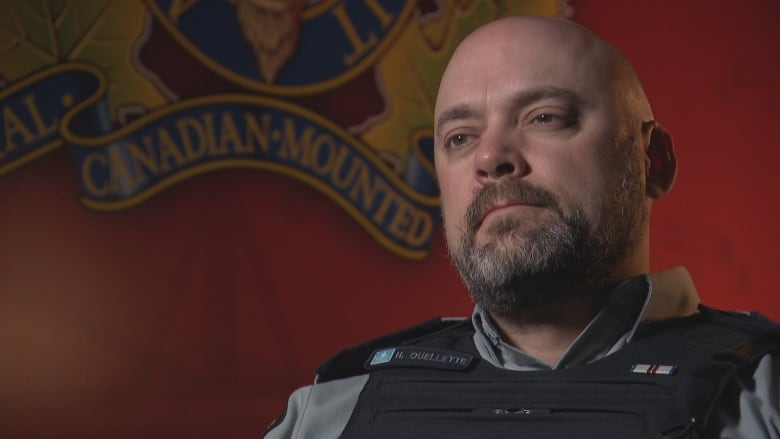 A man in an RCMP uniform looks off camera.