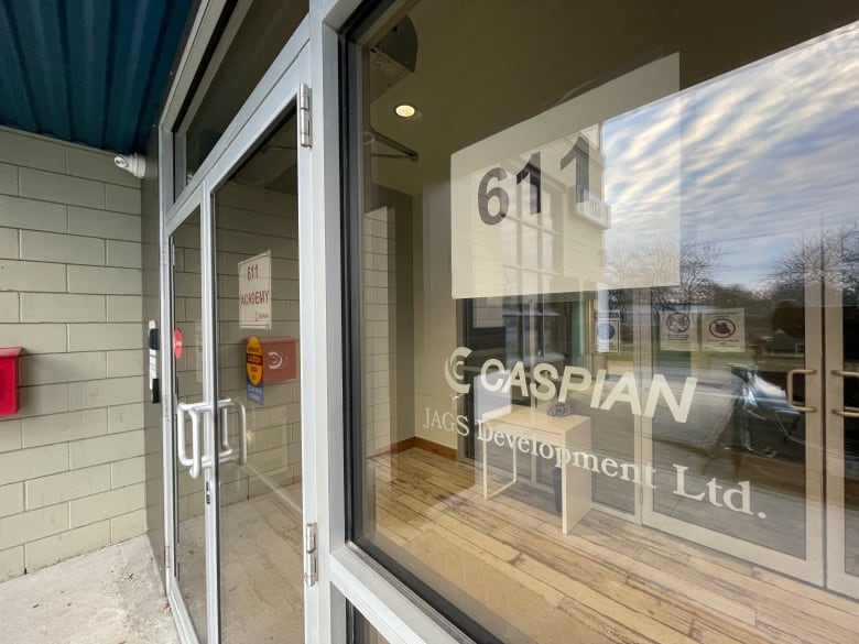 Photo of a window with signs that read Caspian and Jags Development Ltd.