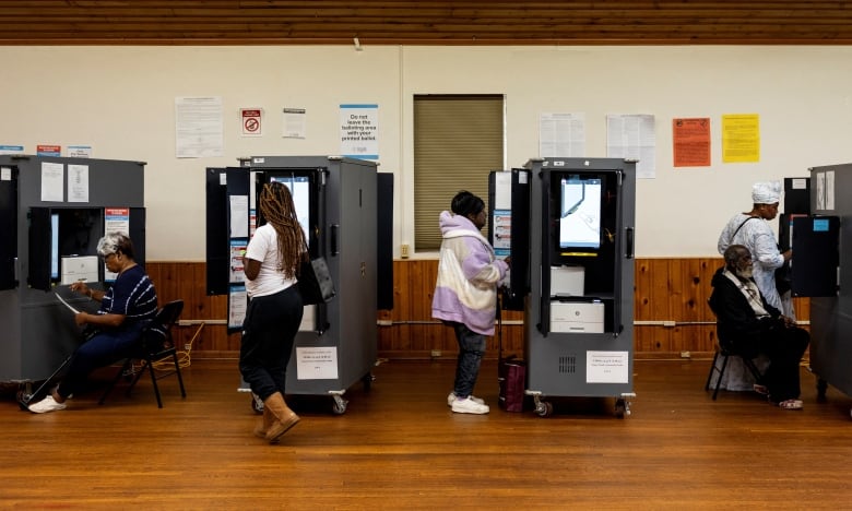 People cast ballots on Election Day at a community centre in College Park, Ga.