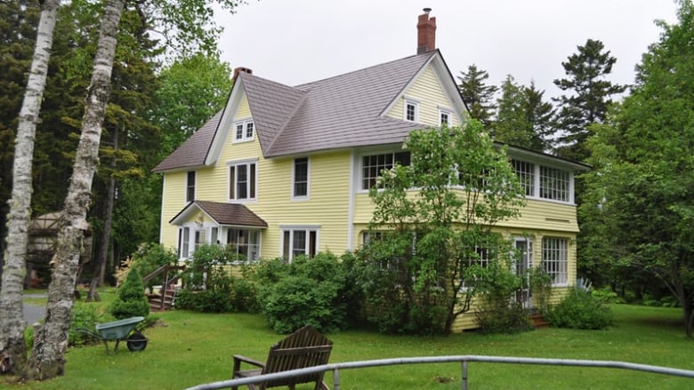 Large home with yellow siding. 