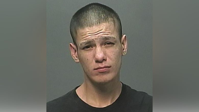 Mug shot of a young Indigenous man.