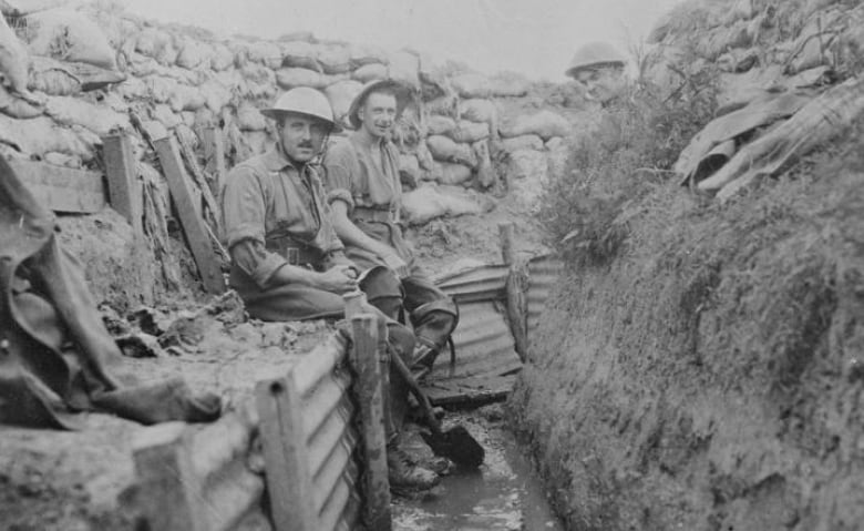 Members of the 22nd Infantry Battalion (French Canadian) are shown draining trenches, July 1916.  