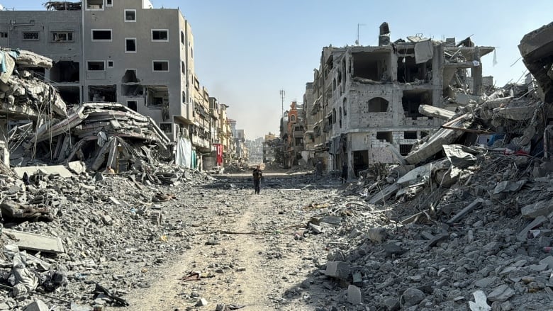 A Palestinian man walks past the rubble after Israeli forces withdrew from the area around Kamal Adwan hospital, amid the ongoing Israel-Hamas conflict, in Jabalia, in the northern Gaza Strip October 26, 2024. 