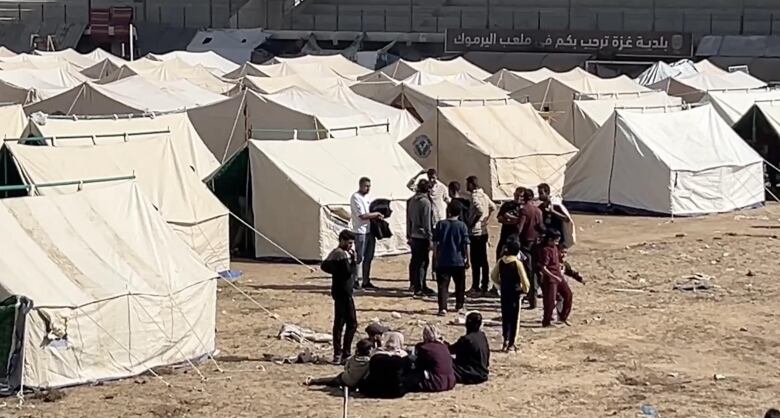 Tents are clustered together in Yarmouk Stadium in Gaza city.  Hundreds of thousands of Palestinians have been displaced from northern areas of the territory - perhaps permanently - and many have sought refuge here.