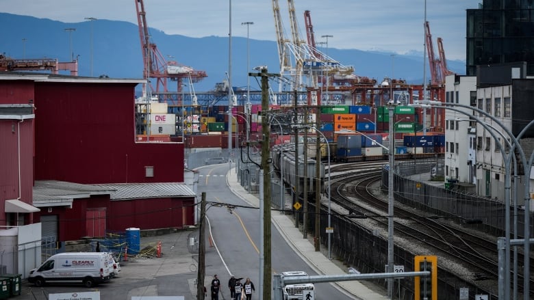 A port is seen with containers and cranes.