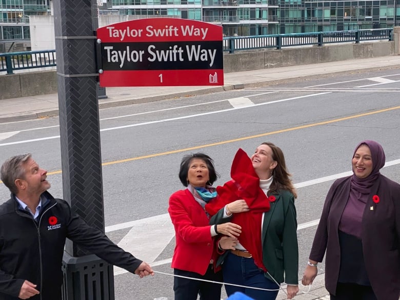 Neil  Hetherington, Daily Bread Food Bank, Toronto Mayor Olivia Chow, Deputy Mayor Jennifer McKelvie and Coun. Ausma Malik at the Taylor Swift Way sign unveiling outside near Rogers Centre.