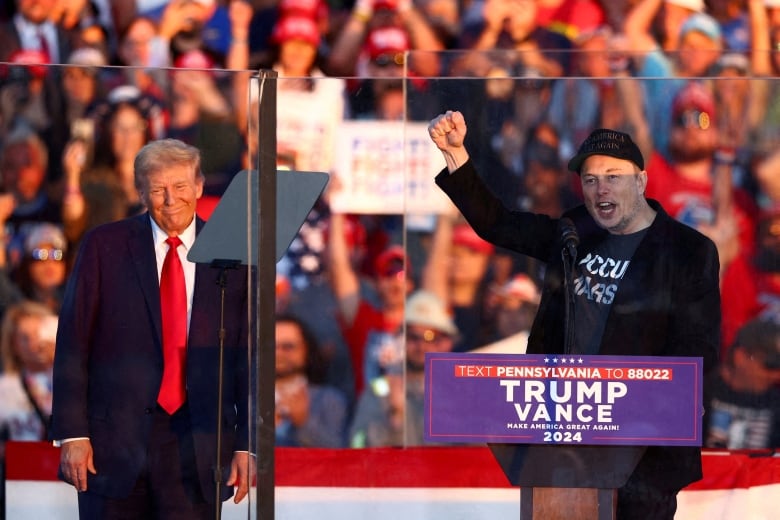 Two men address a crowd.