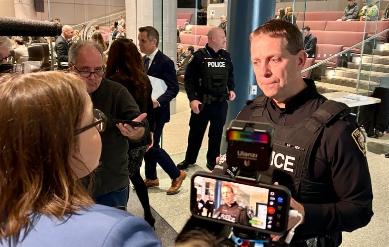 Chief Eric Stubbs scrums with reporters.