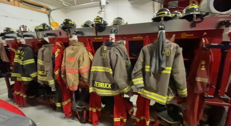 a row of fire fighters coats