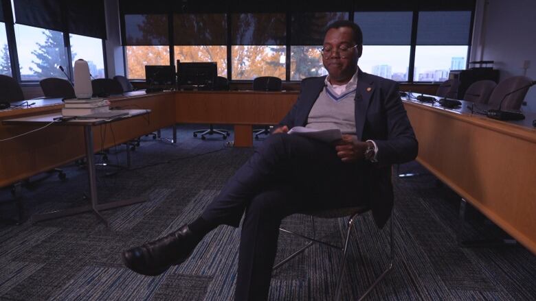 Temitope Oriola is a criminologist and dean at the University of Alberta. He is pictured here reviewing the Alberta Court of King's Bench decision in the Carbert and Olienick criminal trial.