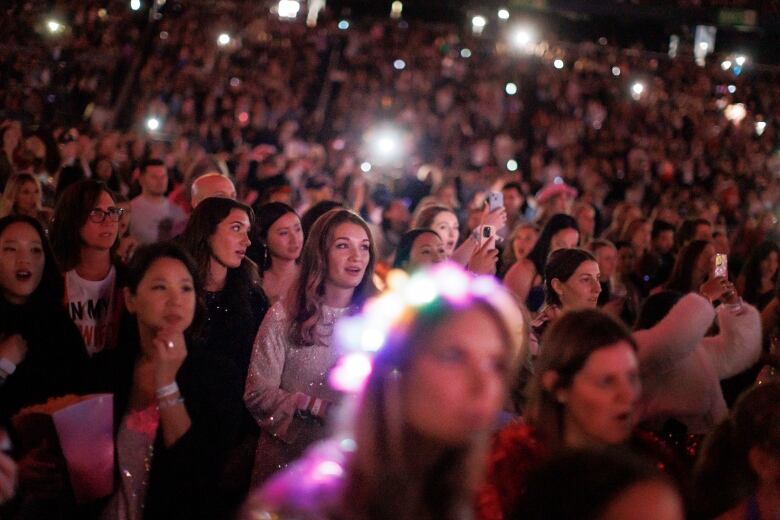 A crowd of fans in the audience at Rogers Centre, listening to Gracie Abrams the opening act for Taylor Swift.