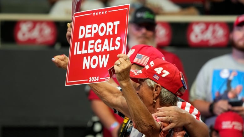 Supporters hold signs before Republican presidential candidate former President Donald Trump speaks at a campaign rally Wednesday, July 24, 2024, in Charlotte, N.C. (AP Photo/Alex Brandon)