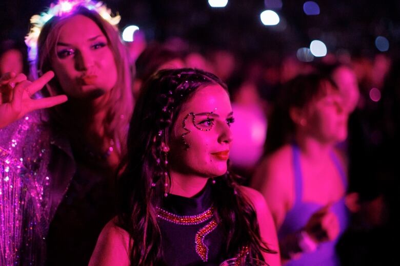 Closeup of fans listening to Gracie Abrams, who opens for Taylor Swift's Eras Tour at Rogers Centre.