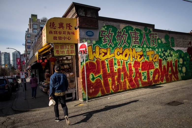 A colourful mural says, Welcome to Chinatown.