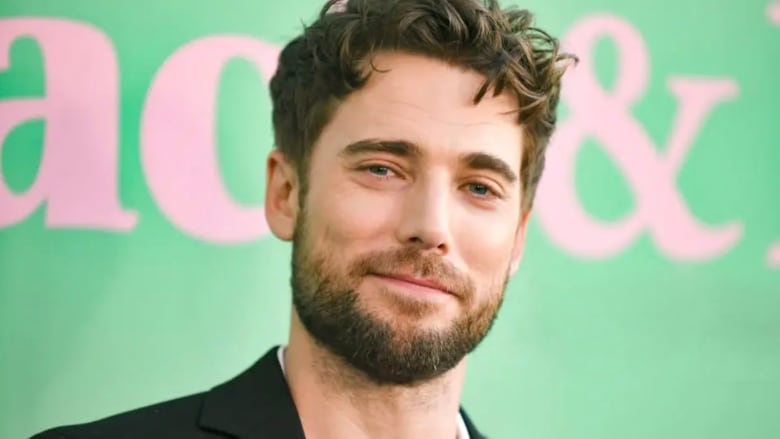 A man with facial hair is seen in a headshot 