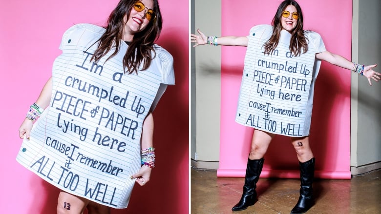 Courtney Rudolph stands for a portrait wearing a dress that looks like lined paper and reads: I'm a crumpled up piece of paper lying here cause I remember it all too well.