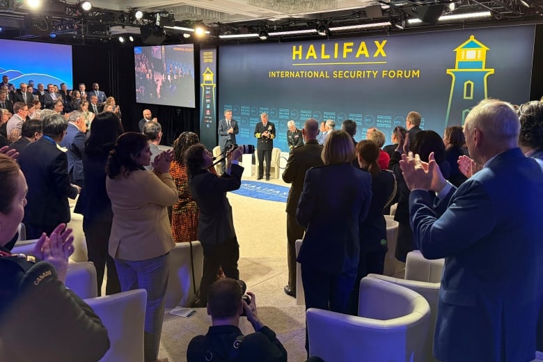 An audience applauds speakers at the Halifax International Security Forum. 