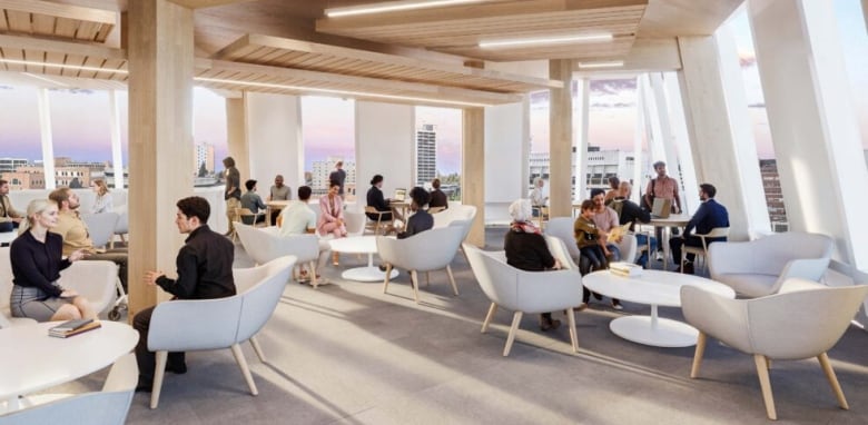 People lounge in chairs around tables in a large, open, sunny room.