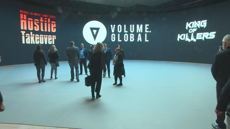 People are milling about in front of the LED volume wall at the provincially owned soundstage in Regina.